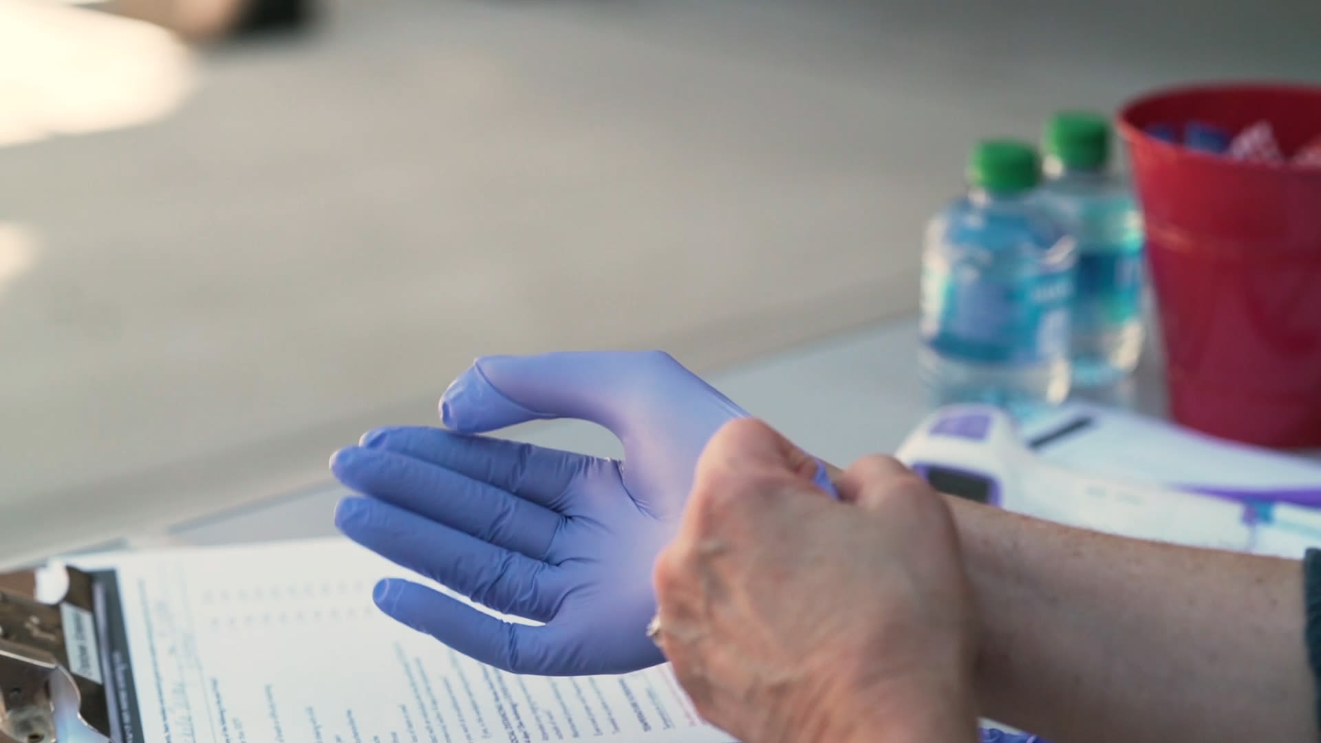 Caretaker putting gloves on at a Anthology of Highland Park community