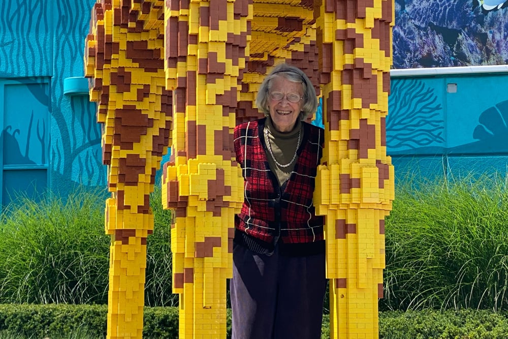 Woman with a giraffe statue  at Anthology of Beaverton in Beaverton, Oregon