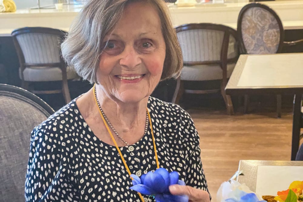 A resident with flowers at Anthology of Highland Park in Dallas, Texas