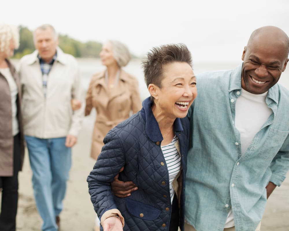 Group of residents walking and talking by the water near Anthology Senior Living in Chicago, Illinois