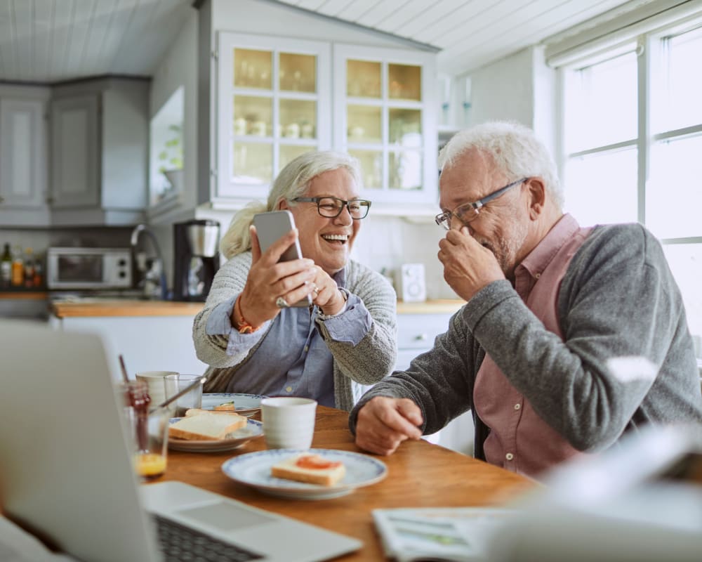 Residents laughing together during breakfast at Anthology of Beaverton in Beaverton, Oregon