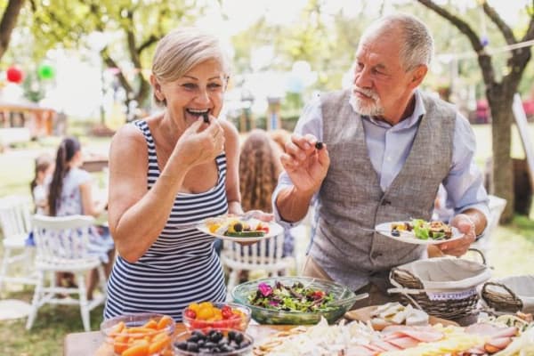 A group of residents outdoors eating food at Anthology of Beaverton in Beaverton, Oregon