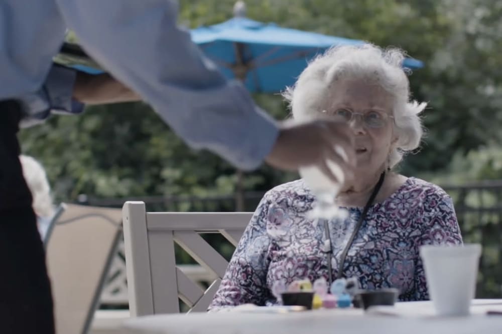 Resident being waited on at a Anthology of Highland Park community